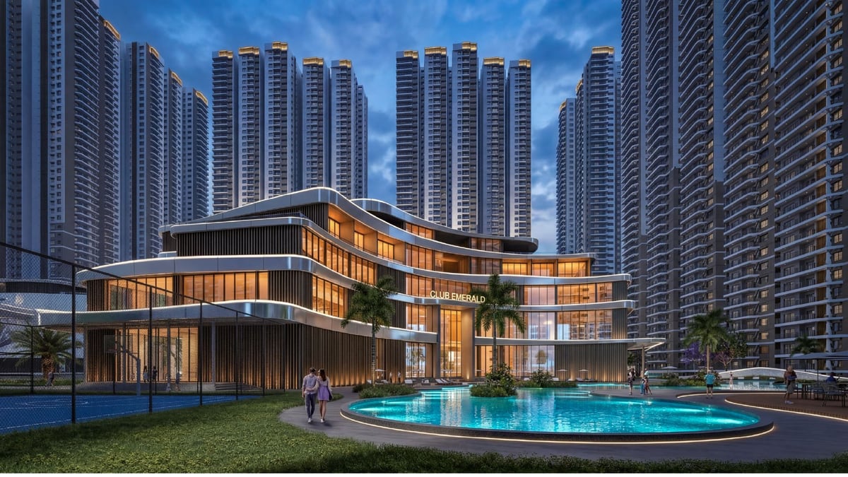 Wide aerial of the Prestige Kollur township pool and grove spine—campaign artwork.